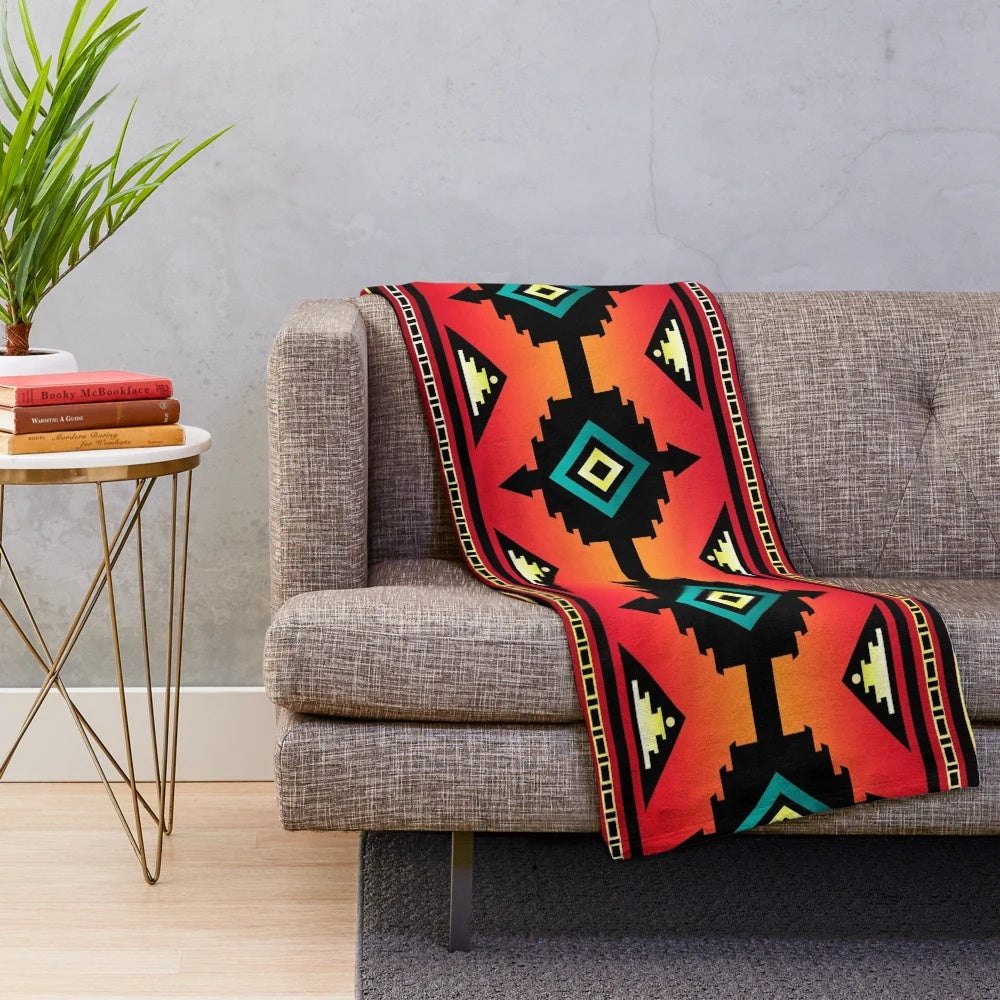 Navajo-inspired plush blanket with vibrant geometric patterns and teal border
