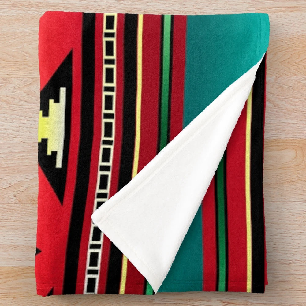 Navajo-inspired plush blanket with vibrant geometric patterns and teal border