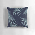 A digital art pillow featuring a collage of navy blue palm leaves and tropical foliage, perfect for adding a touch of summer style to your home.