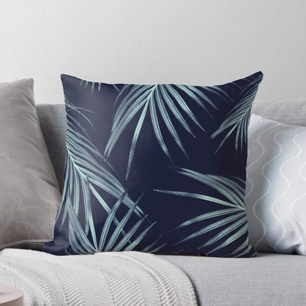 A digital art pillow featuring a collage of navy blue palm leaves and tropical foliage, perfect for adding a touch of summer style to your home.