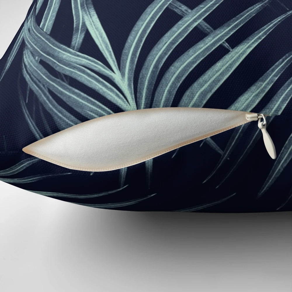 A digital art pillow featuring a collage of navy blue palm leaves and tropical foliage, perfect for adding a touch of summer style to your home.