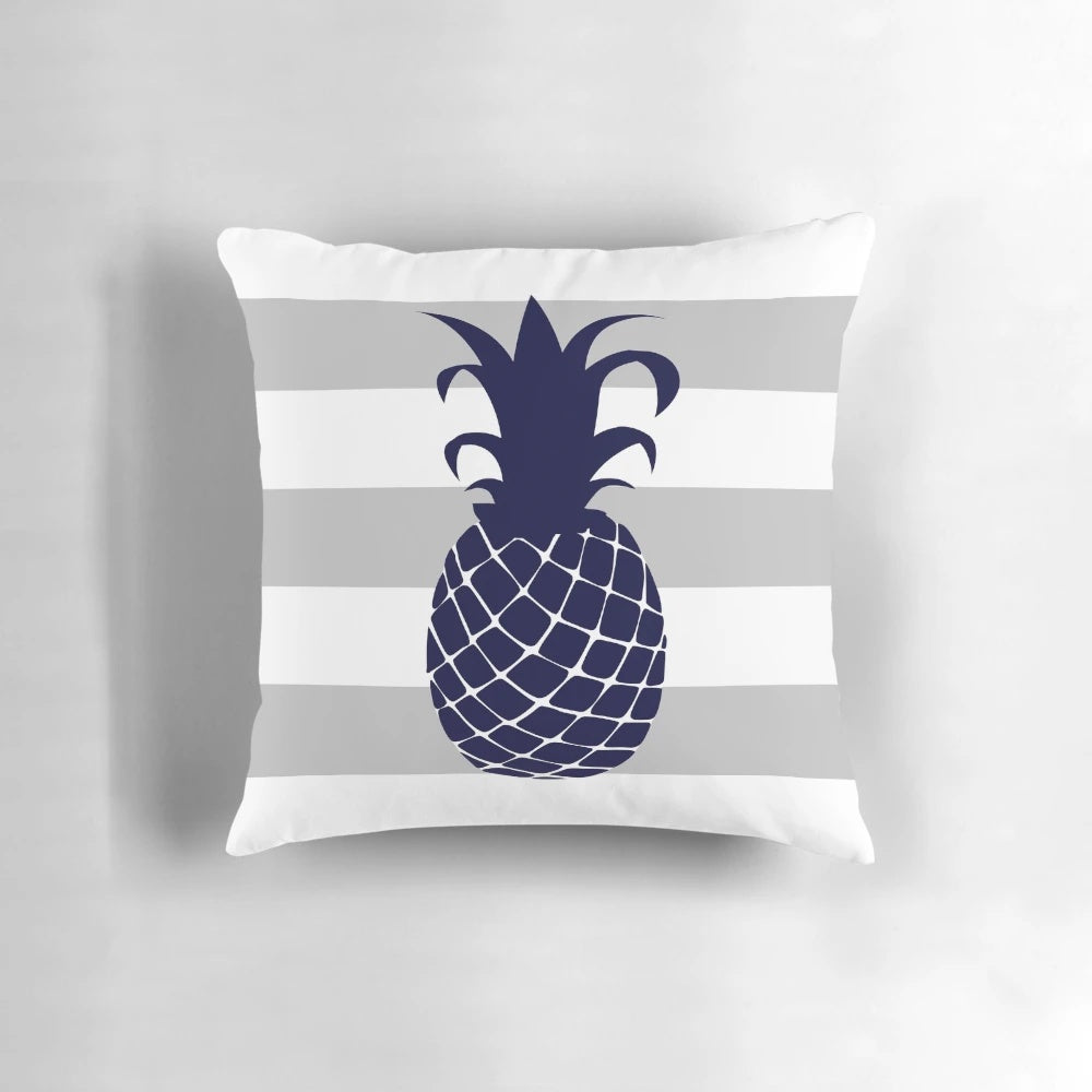 Navy blue and silver gray striped pillow with a bright pineapple design, perfect for tropical or coastal home decor