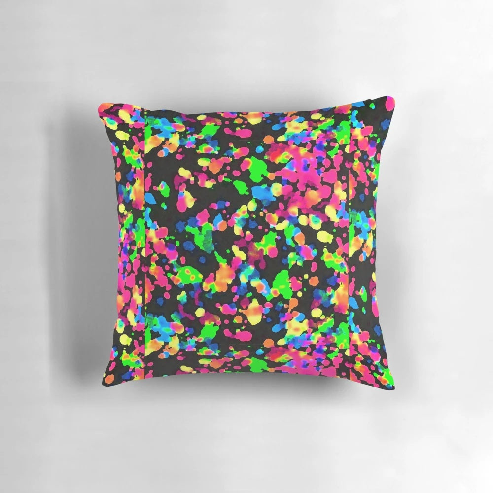 Neon paint splatter blacklight pillow with a vibrant, trippy design