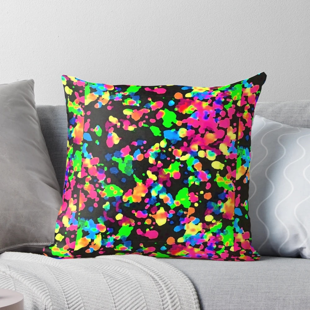Neon paint splatter blacklight pillow with a vibrant, trippy design