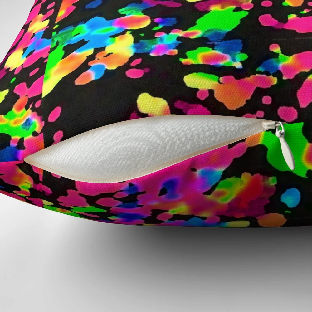 Neon paint splatter blacklight pillow with a vibrant, trippy design