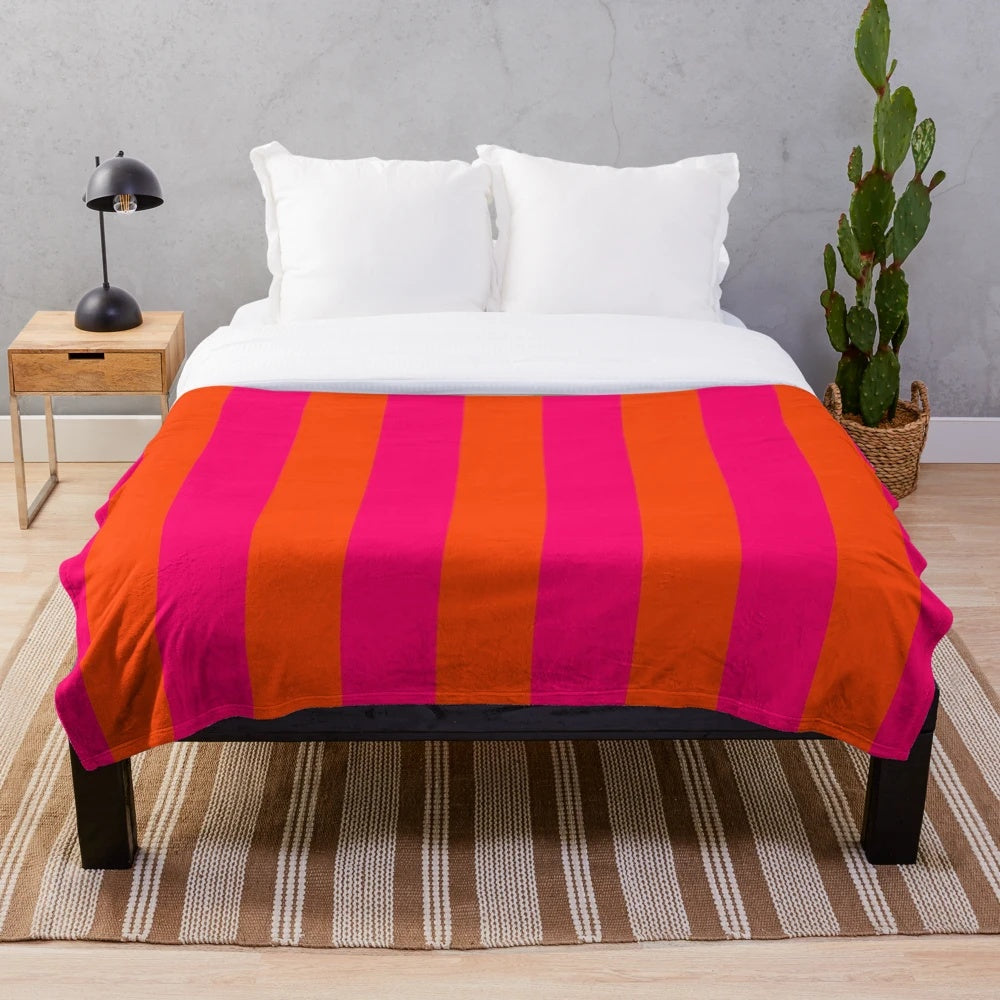 Neon pink and orange striped plush blanket with vertical cabana-style pattern