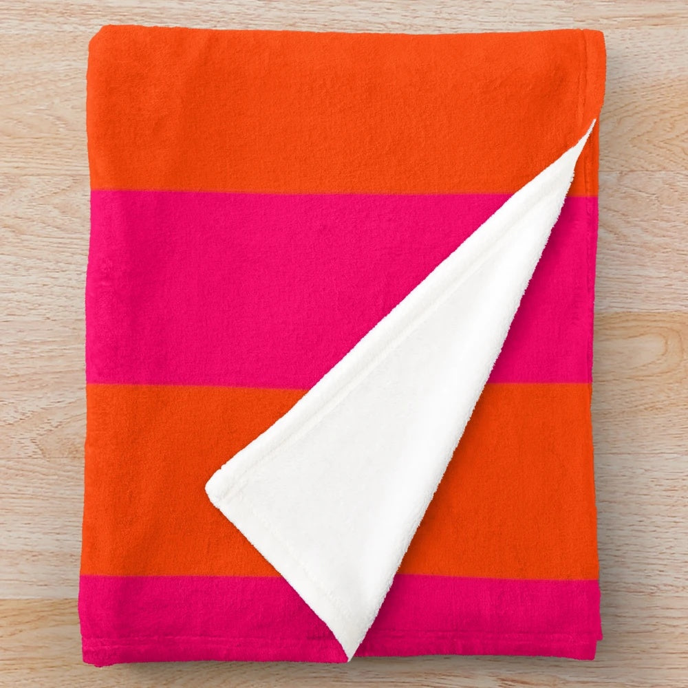 Neon pink and orange striped plush blanket with vertical cabana-style pattern