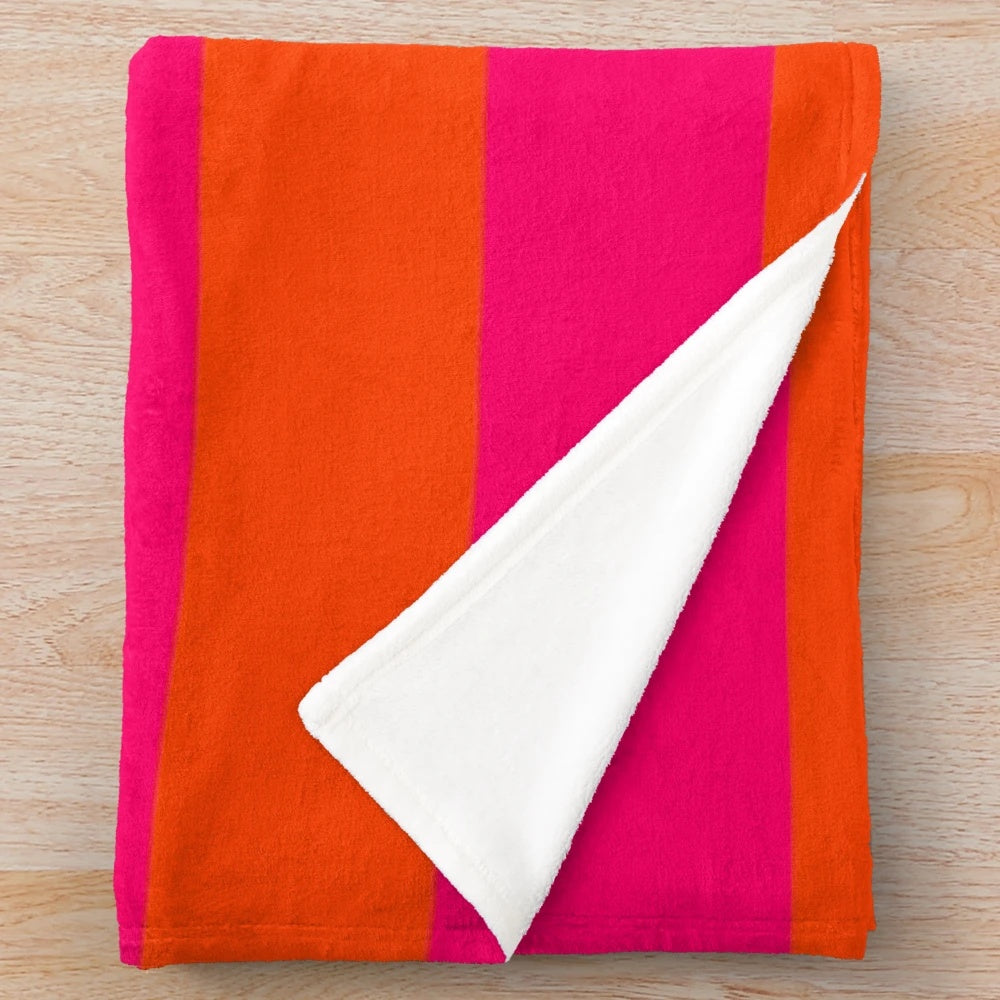 Neon pink and orange striped plush blanket