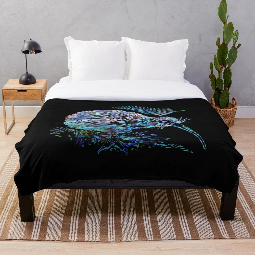 Colorful plush blanket featuring a paua shell design, kiwi, and ferns, representing the beauty of New Zealand