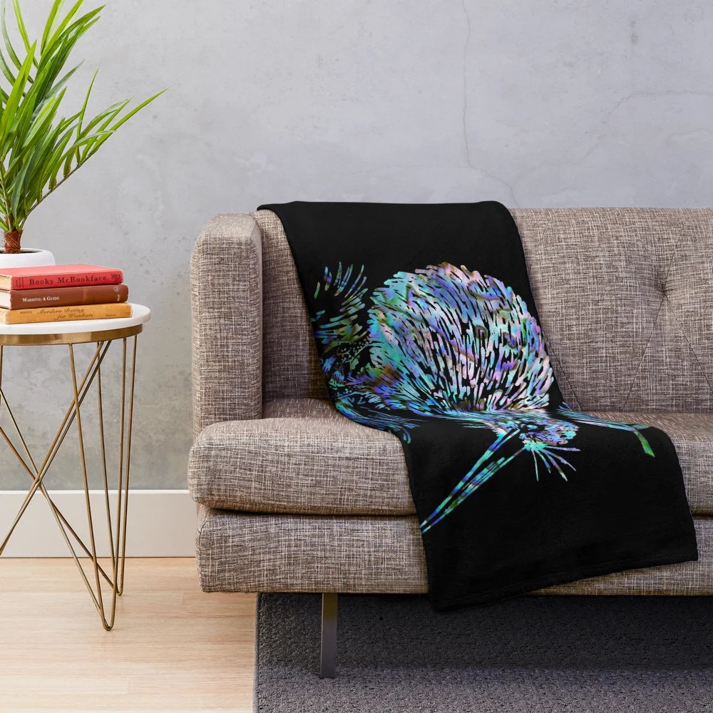 Colorful plush blanket featuring a paua shell design, kiwi, and ferns, representing the beauty of New Zealand
