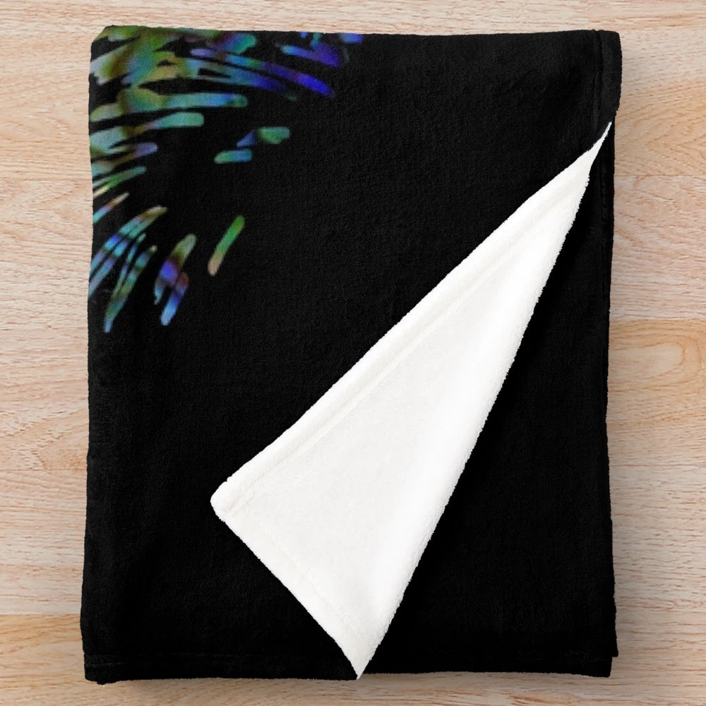 Colorful plush blanket featuring a paua shell design, kiwi, and ferns, representing the beauty of New Zealand