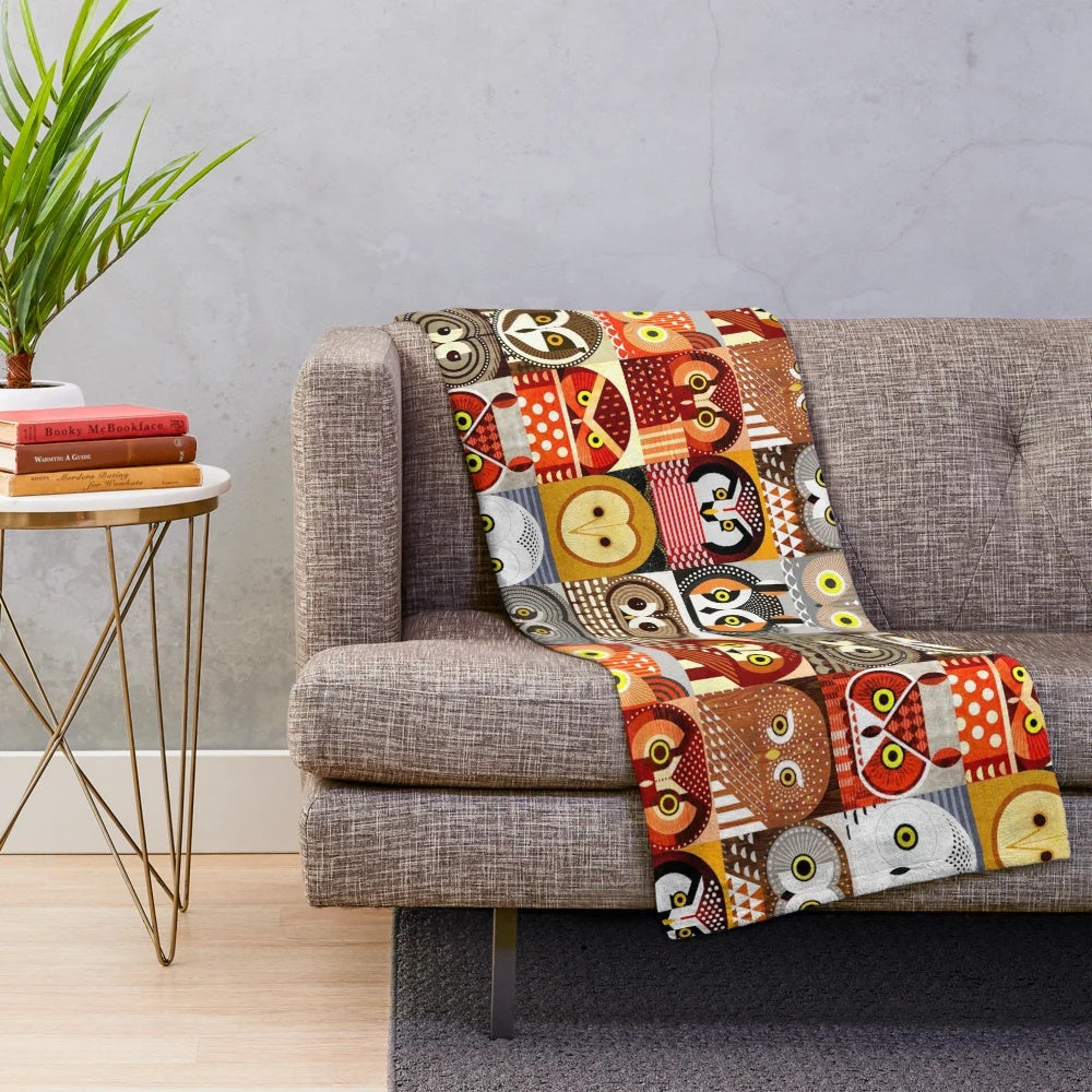 Colorful and geometric plush blanket featuring illustrations of North American owls