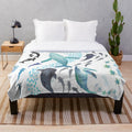 Colorful plush blanket featuring watercolor designs of ocean animals including whales, sharks, and sea turtles