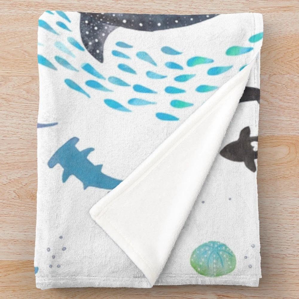 Colorful plush blanket featuring watercolor designs of ocean animals including whales, sharks, and sea turtles