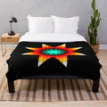 Plush blanket with a vibrant star quilt pattern in fire colors inspired by Ojibwe floral designs