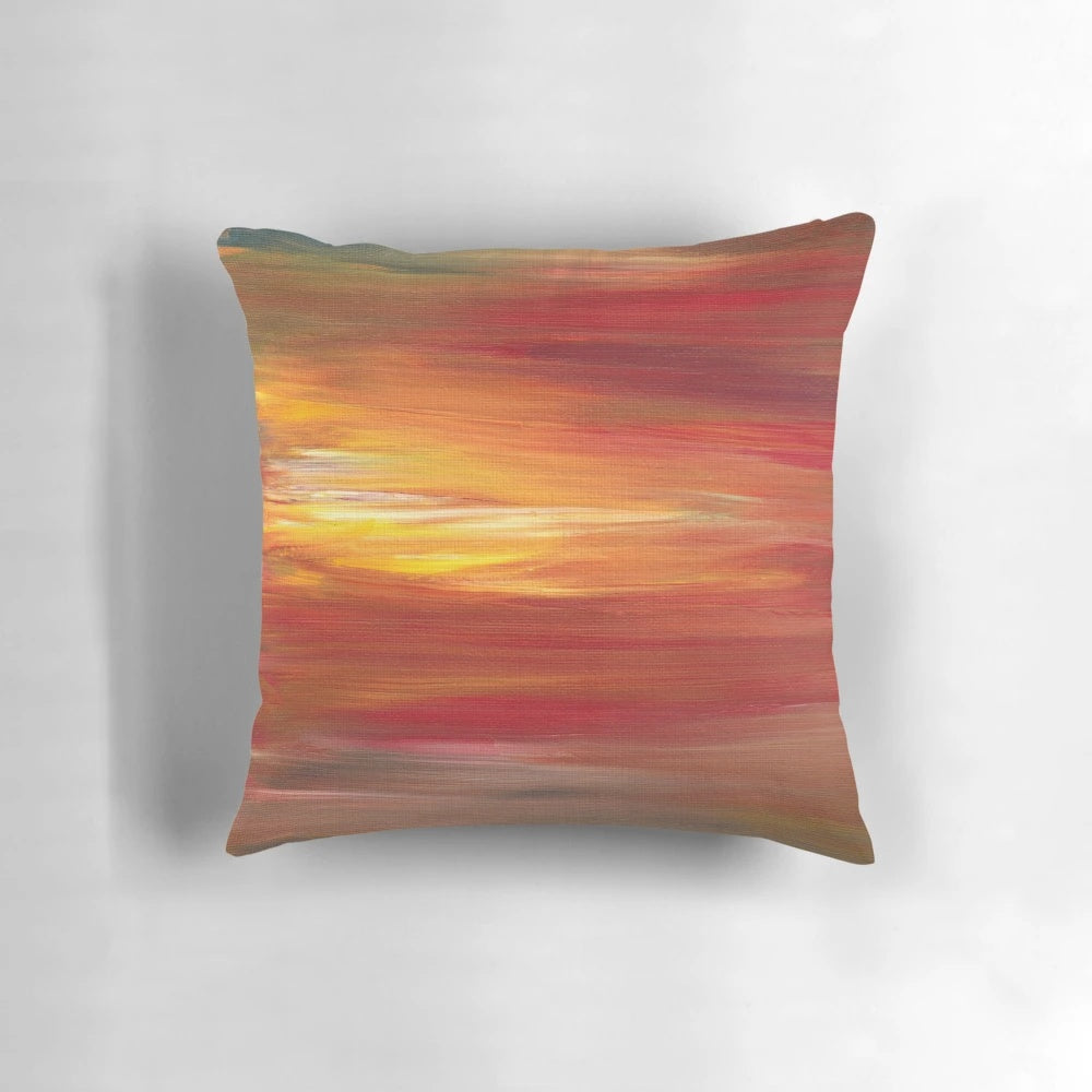 Colorful abstract ombre painting in shades of red, yellow, and black on a decorative throw pillow.