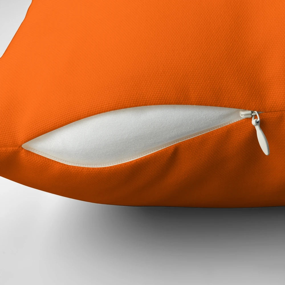 Solid orange accent pillow with a minimalist design, perfect for adding a pop of color to your living space.