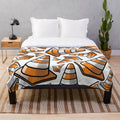 Plush blanket with a vibrant traffic cone pattern