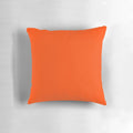 Vibrant orange red pillow with a solid color design and a range of orange shades.