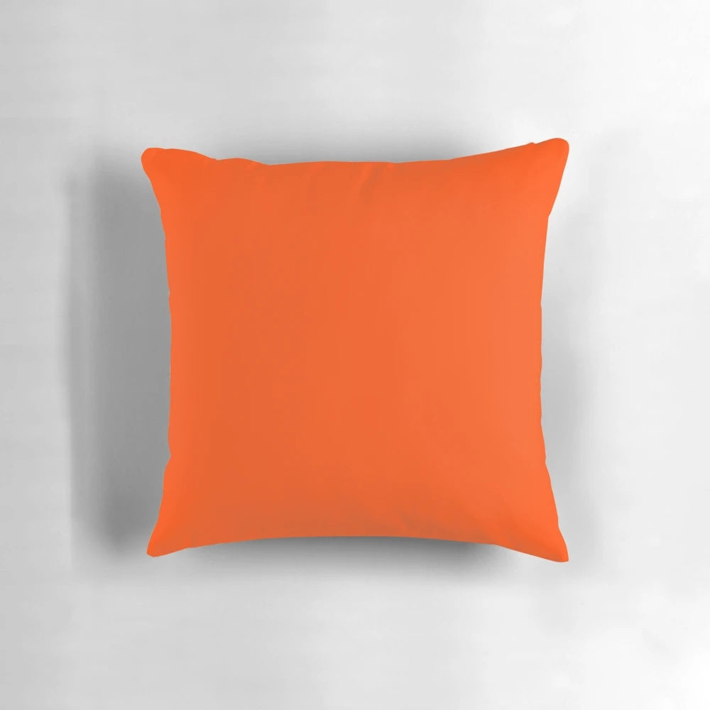 Vibrant orange red pillow with a solid color design and a range of orange shades.