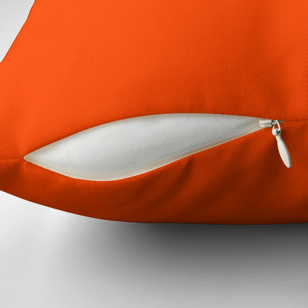 Vibrant orange red pillow with a solid color design and a range of orange shades.