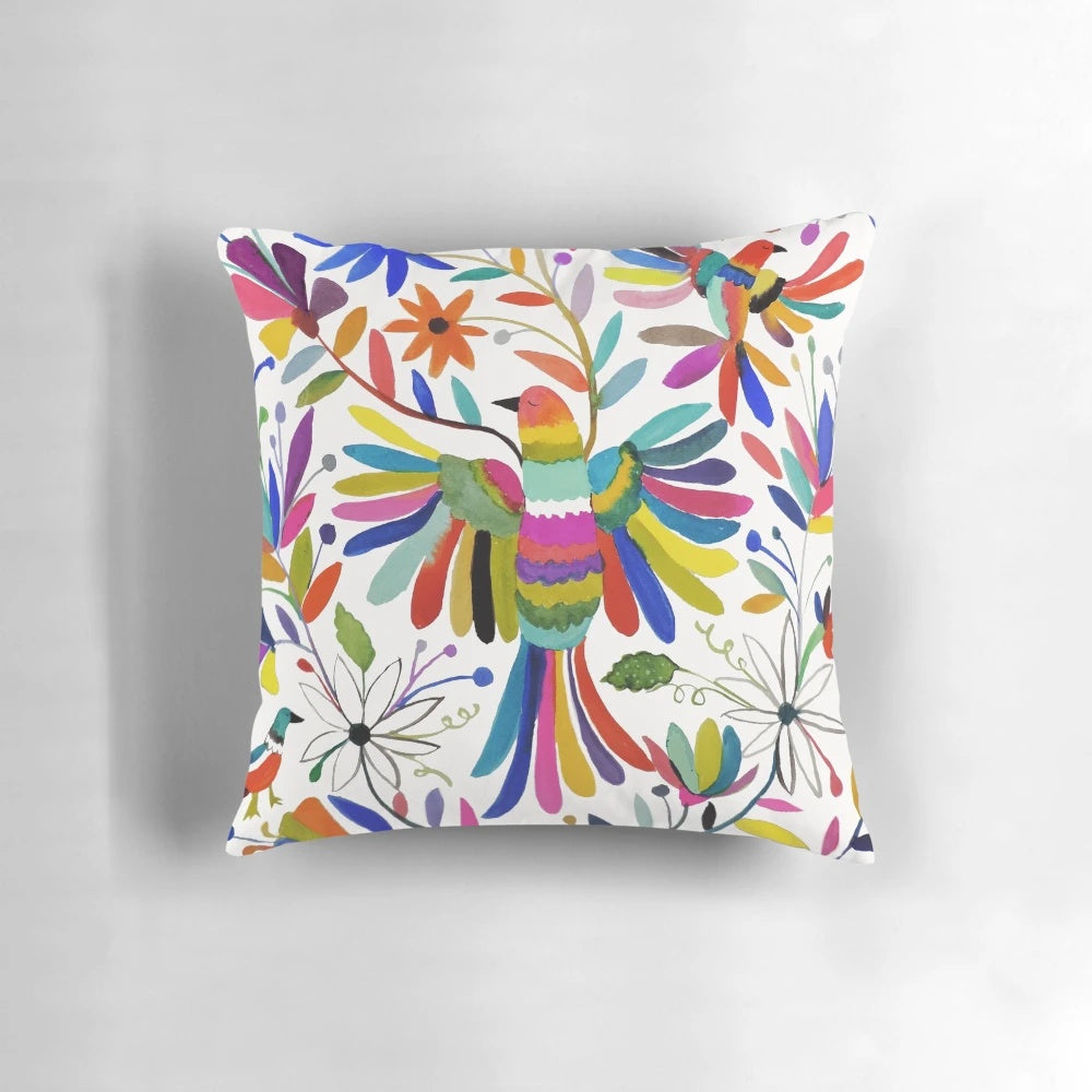 Colorful Otomi bird pattern print on a fluffy throw pillow, perfect for bohemian home decor