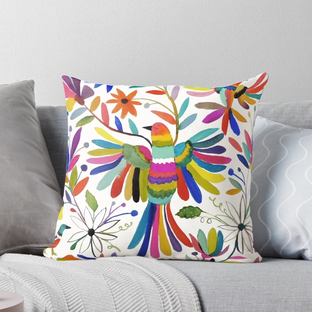 Colorful Otomi bird pattern print on a fluffy throw pillow, perfect for bohemian home decor