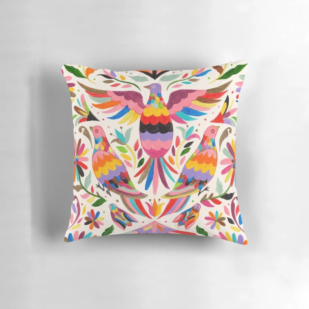 Colorful Otomi-inspired bird pattern on a decorative throw pillow