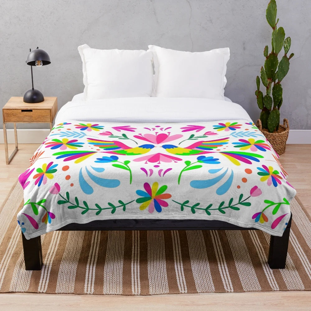 Otomi-inspired plush blanket with colorful floral and animal patterns