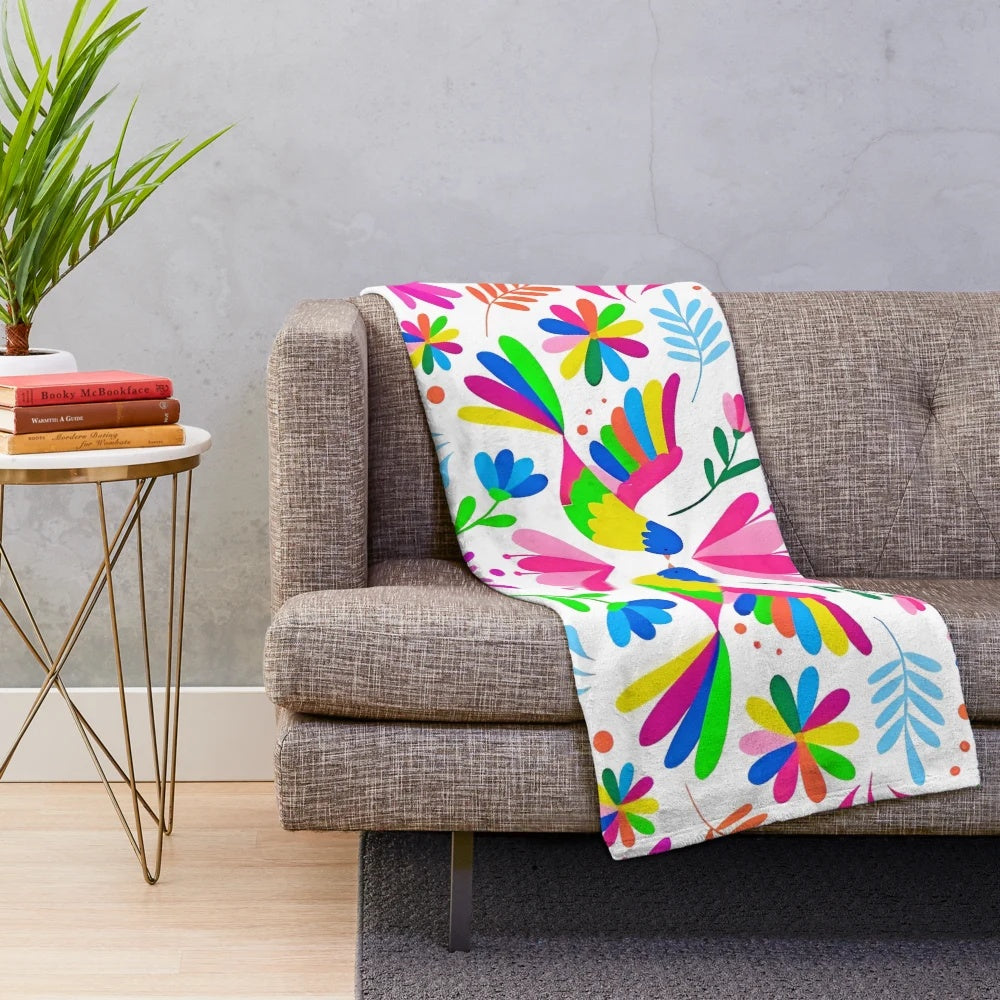 Otomi-inspired plush blanket with colorful floral and animal patterns
