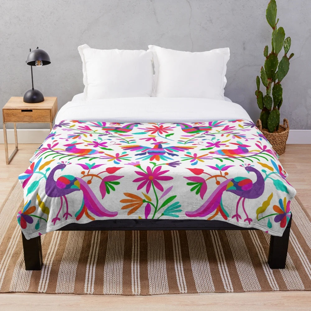 Colorful Otomi-inspired plush blanket featuring traditional Mexican patterns and designs