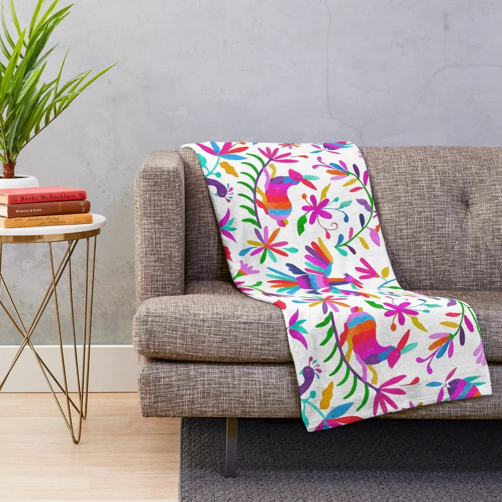 Colorful Otomi-inspired plush blanket featuring traditional Mexican patterns and designs