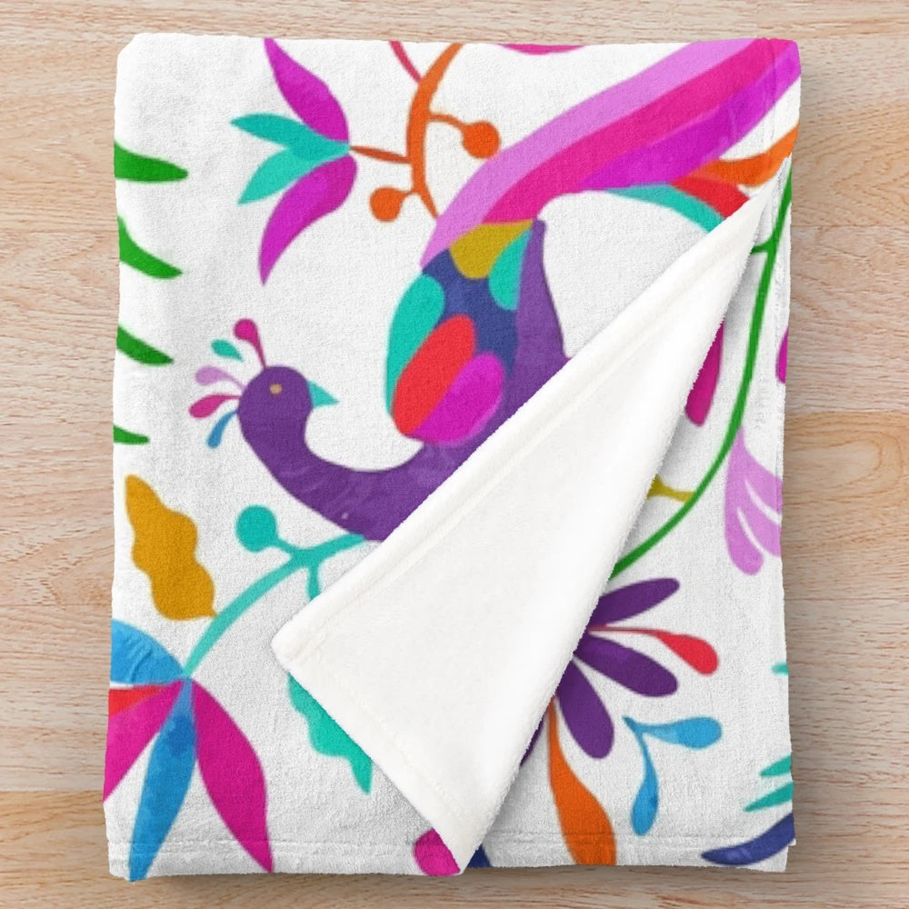 Colorful Otomi-inspired plush blanket featuring traditional Mexican patterns and designs