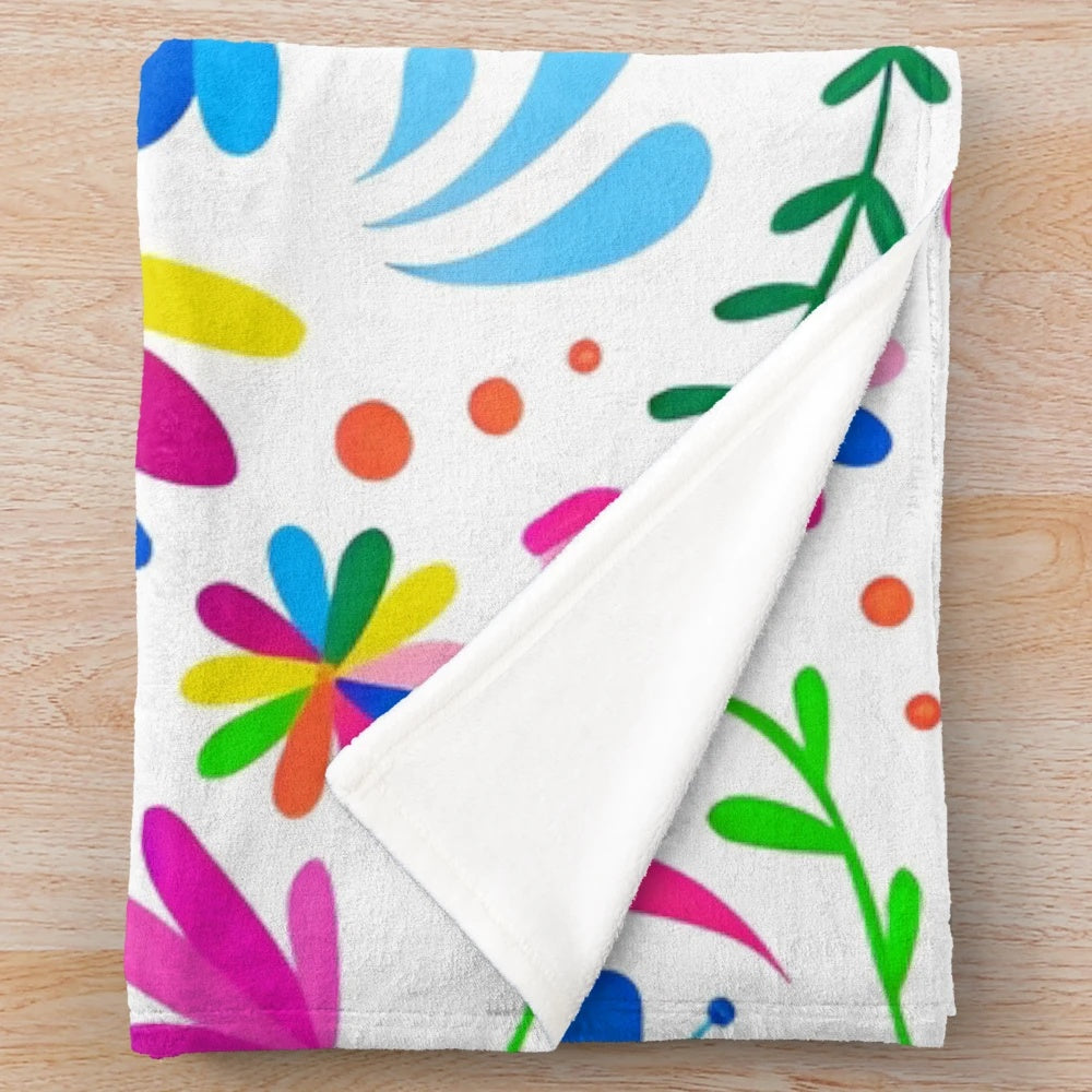 Otomi-inspired plush blanket with colorful floral and animal patterns