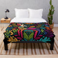 Colorful otomi-inspired plush blanket with floral and bird motifs