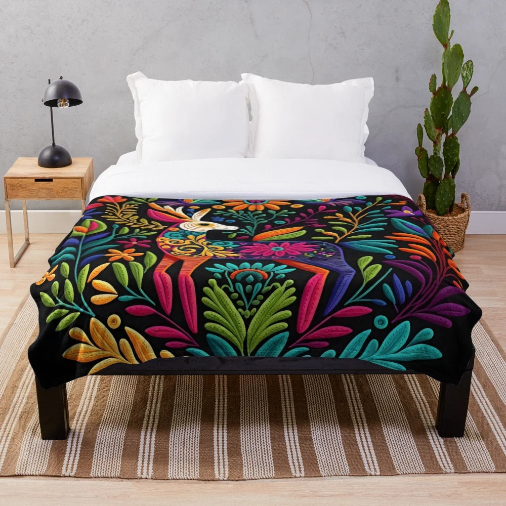 Colorful otomi-inspired plush blanket with floral and bird motifs