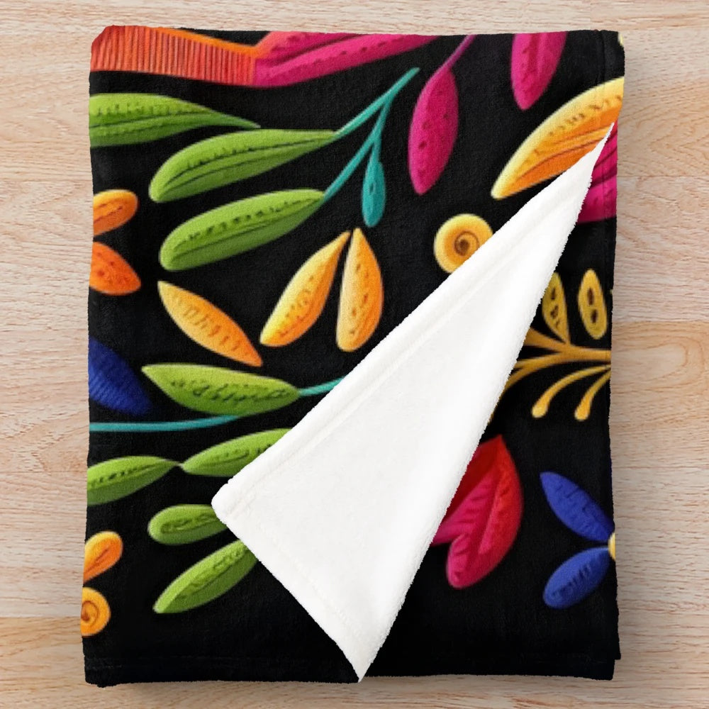 Colorful otomi-inspired plush blanket with floral and bird motifs