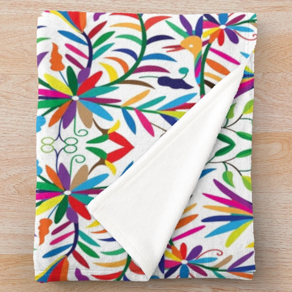 Otomi-inspired colorful plush blanket with vibrant floral and geometric patterns