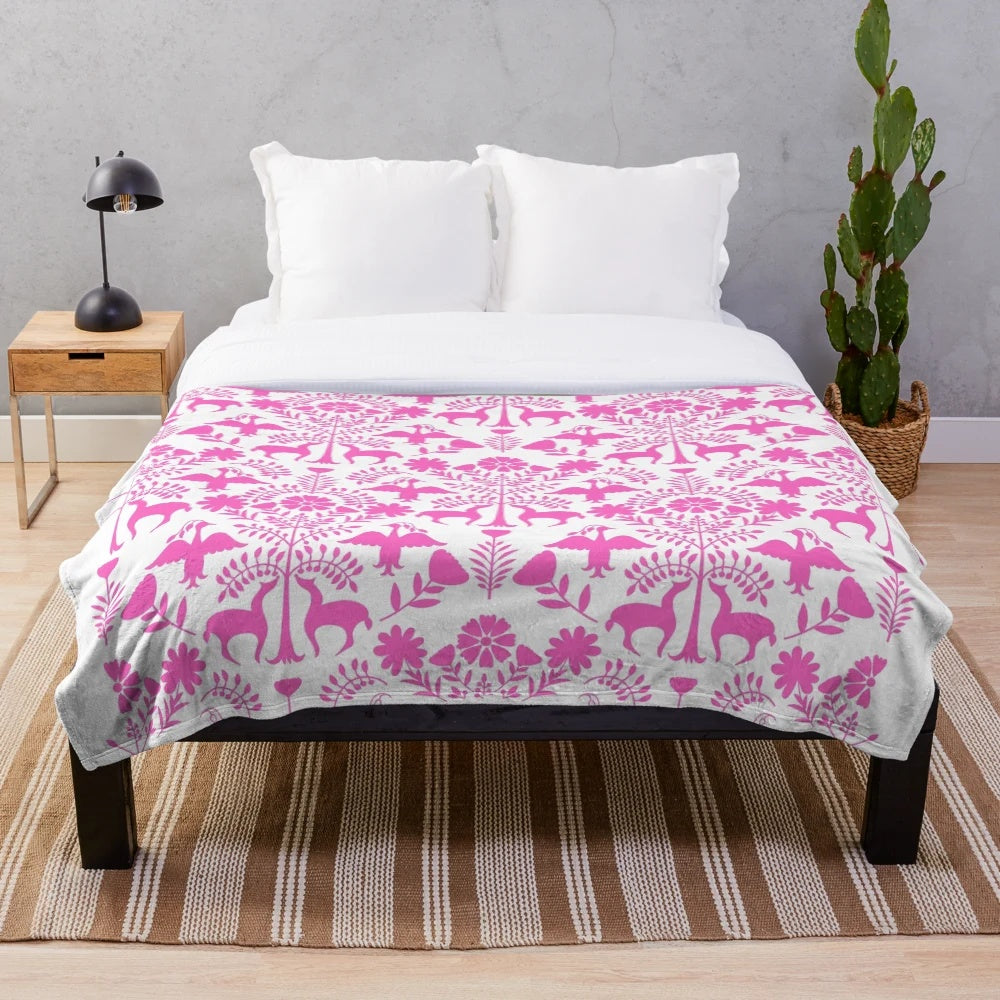 Colorful Otomi-inspired plush blanket with Mexican folk art patterns