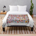Colorful Otomi-inspired plush blanket with traditional Mexican art patterns