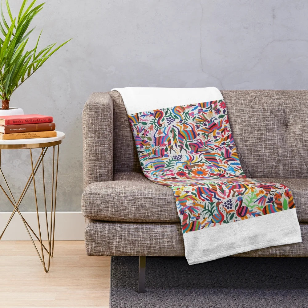 Colorful Otomi-inspired plush blanket with traditional Mexican art patterns