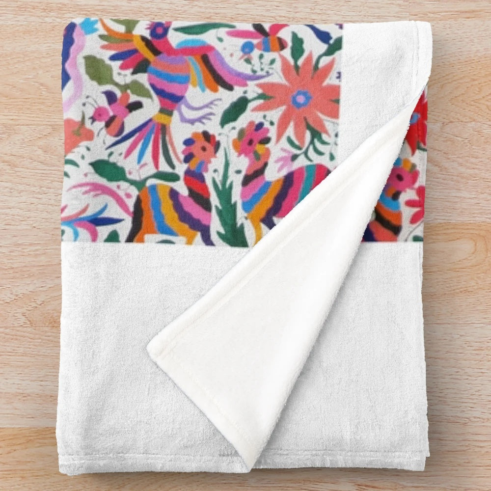 Colorful Otomi-inspired plush blanket with traditional Mexican art patterns