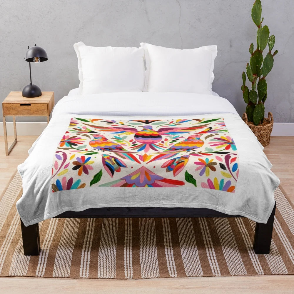 Otomi-inspired plush blanket with colorful Mexican folk art patterns