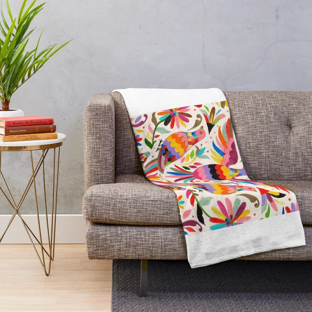 Otomi-inspired plush blanket with colorful Mexican folk art patterns