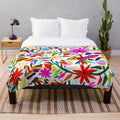 Colorful Otomi Tenango inspired plush blanket with floral and nature motifs