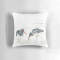 A vibrant watercolor painting of an oystercatcher seabird on a decorative pillow