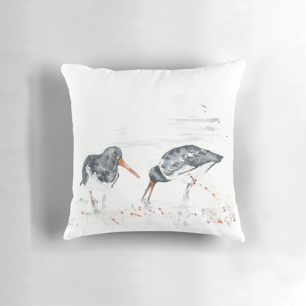 A vibrant watercolor painting of an oystercatcher seabird on a decorative pillow