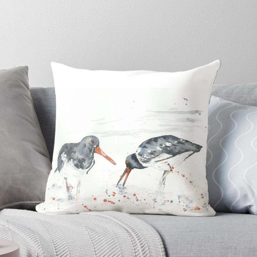 A vibrant watercolor painting of an oystercatcher seabird on a decorative pillow