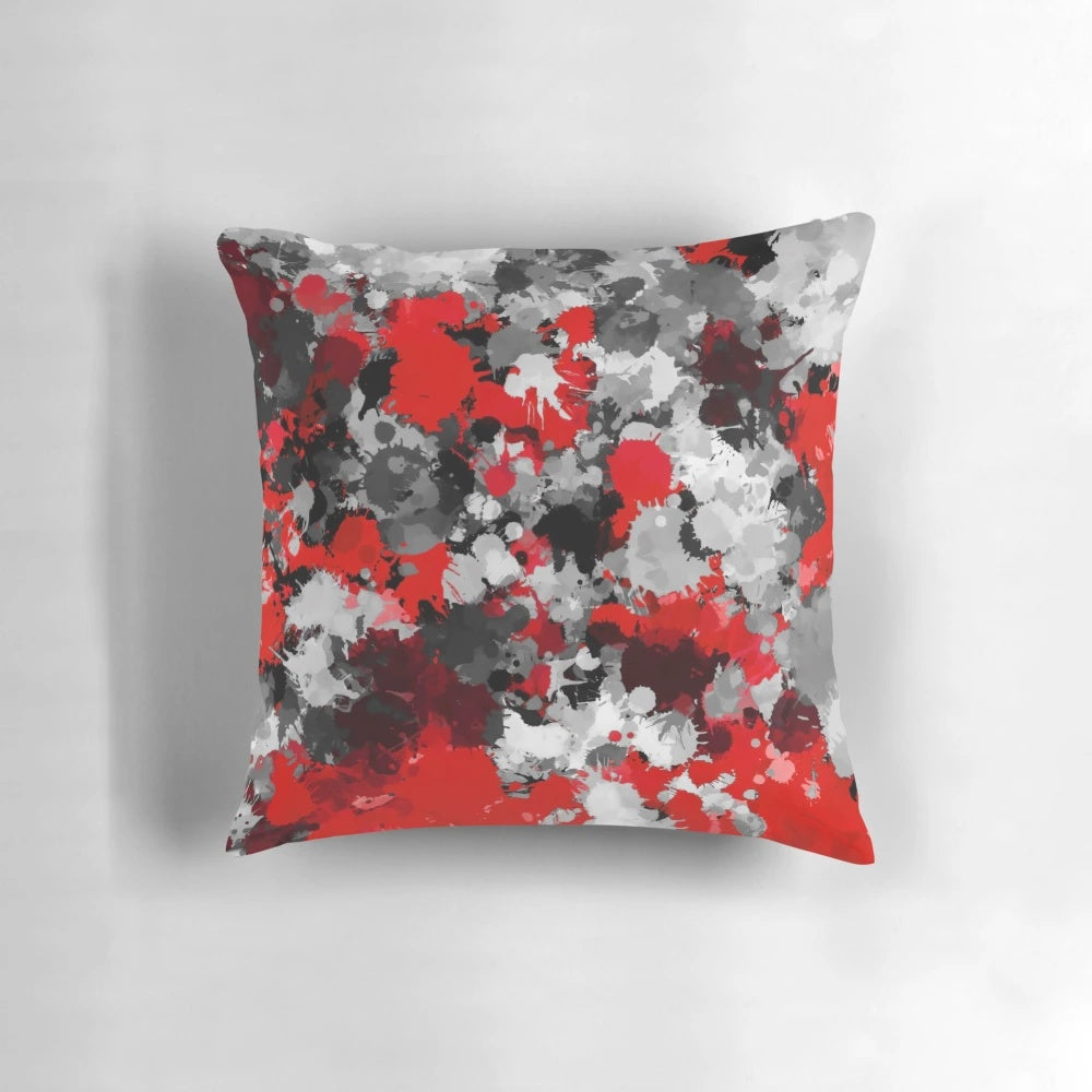 Colorful paint splatter pattern decorative pillow in red, grey, and white