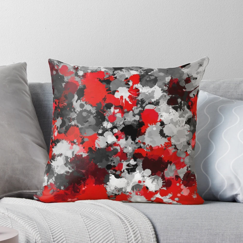 Colorful paint splatter pattern decorative pillow in red, grey, and white